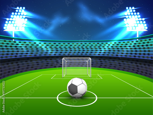 Night view of a soccer ground with flud lights, goal net and soccer ball.