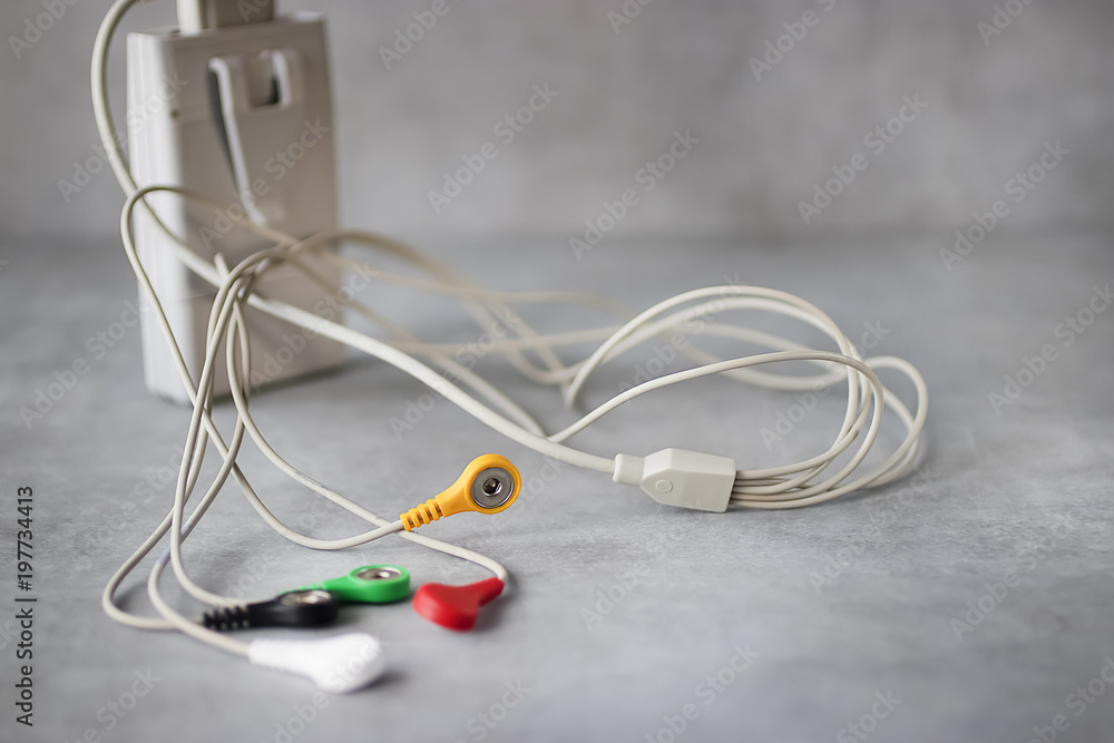 Holter monitoring device on gray background. Holter monitoring device on gray background.
