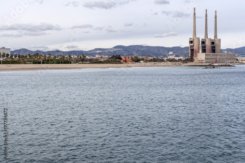 Mediterranean beach and three chimney of old thermal power plant, Sant Adria de Besos, province Barcelona,Catalonia.Spain.