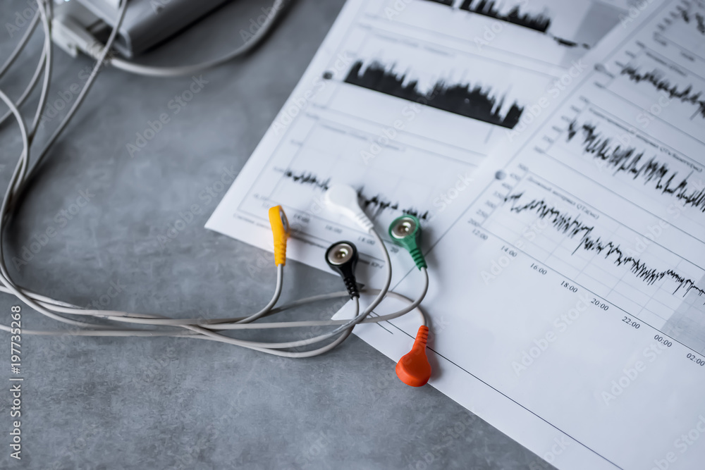 Holter monitoring device on gray background. Holter monitoring device on gray background.
