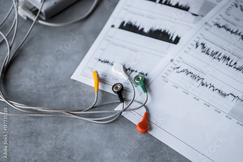 Holter monitoring device on gray background.