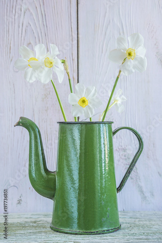 Fototapeta Naklejka Na Ścianę i Meble -  Bouquet of white daffodils in old green pot on white wooden background