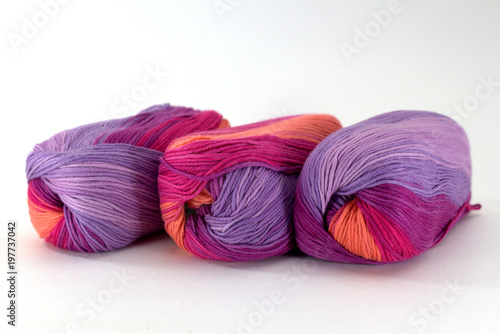 Three coils of sectional yarn for needlework on a white background close-up