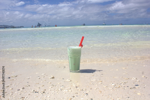 cocktail from a kiwi with milk on the beach