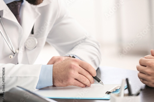 Doctor consulting male patient in clinic