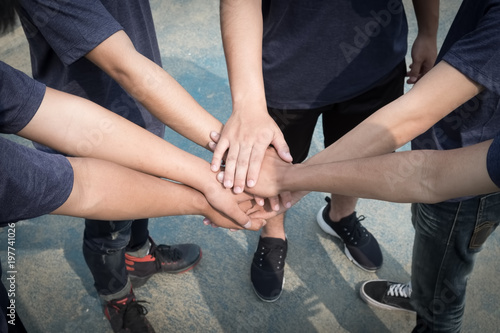 Group of people joining their hands. Teamwork concept.