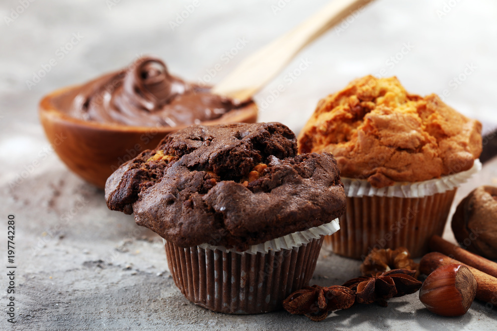 Chocolate muffin and nut muffin, homemade bakery on grey background Chocolate muffin and nut muffin, homemade bakery on grey background