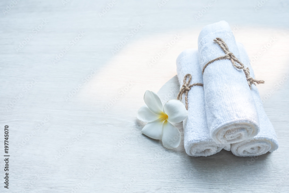 Beautiful spa composition white towel on wooden table. Beautiful spa composition white towel on wooden table.
