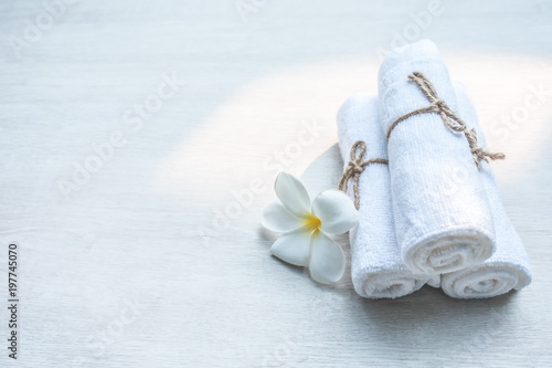 Beautiful spa composition white towel on wooden table.