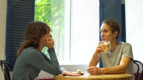 Wallpaper Mural Happy attractive couple having a meeting in hipster cafe Torontodigital.ca