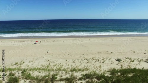 Aerial shot of the beach with people relaxing photo