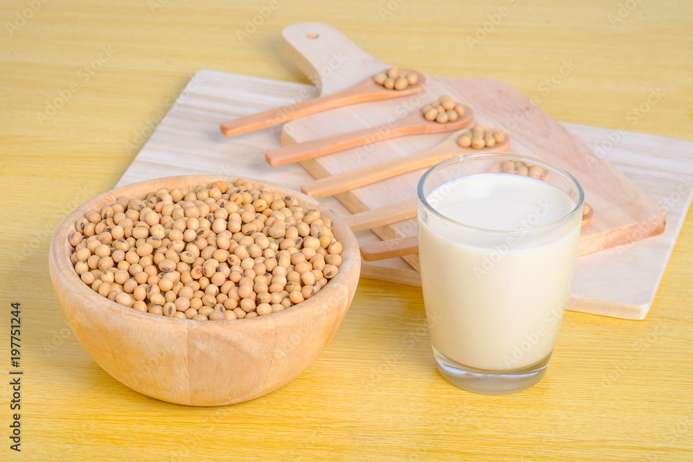 soy milk and soy seeds in wooden bowl soy milk and soy seeds in wooden bowl