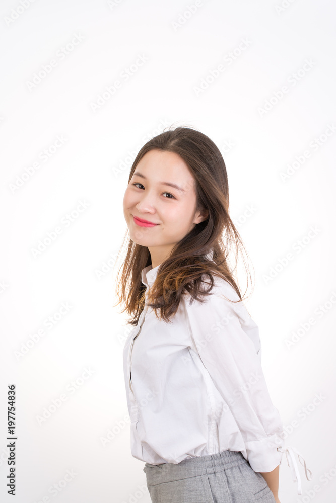 Smiling Young Woman touching her Long and Healthy Hair. Portrait of Young Business Woman.

