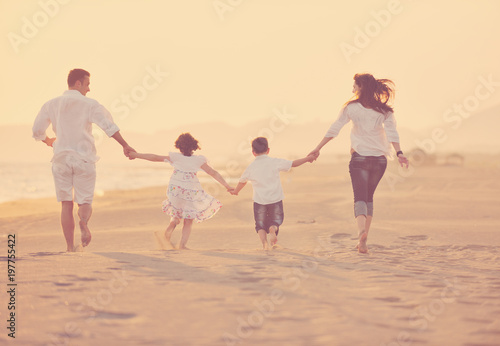 happy young family have fun on beach at sunset © .shock
