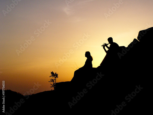 Silhouette of couple at sunset, Khandala, India