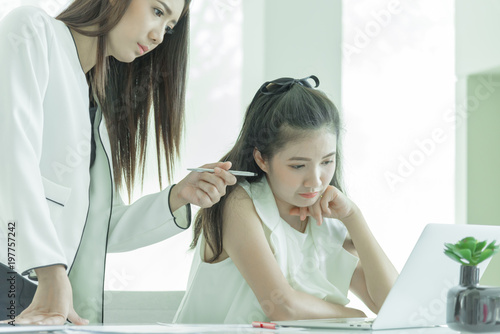 Wallpaper Mural Businesswoman manager has teaching to work for new employee with intention and seriously in the office interior. Torontodigital.ca