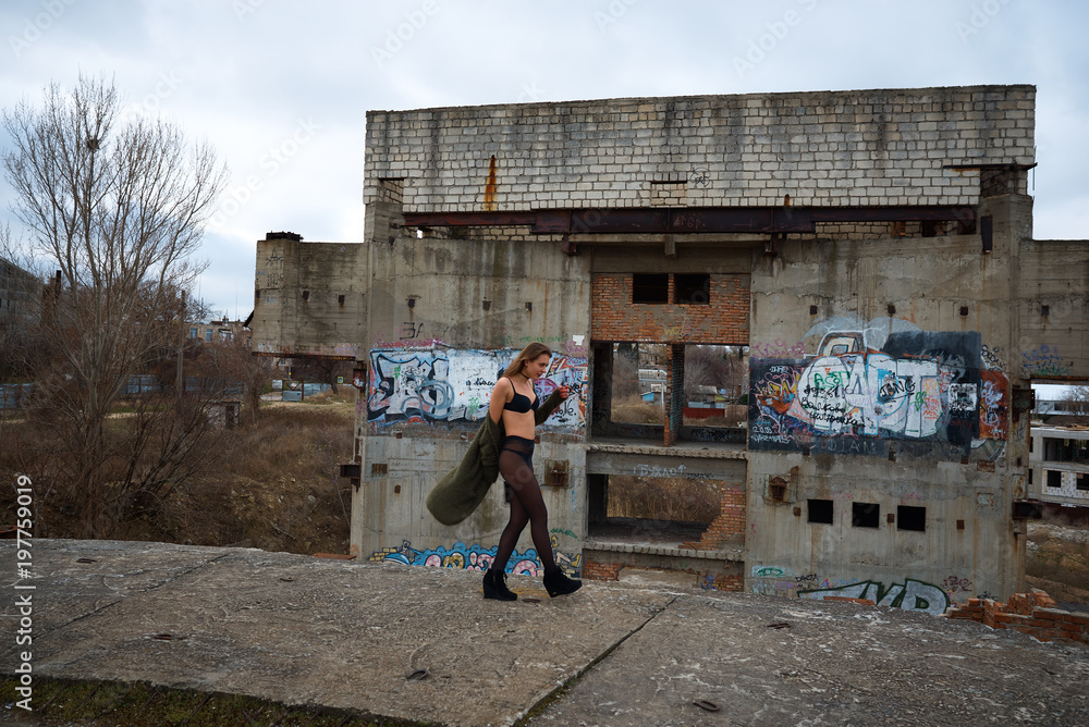 Young slim brunette in lingerie on a ruins of abandoned building Stock  Photo | Adobe Stock