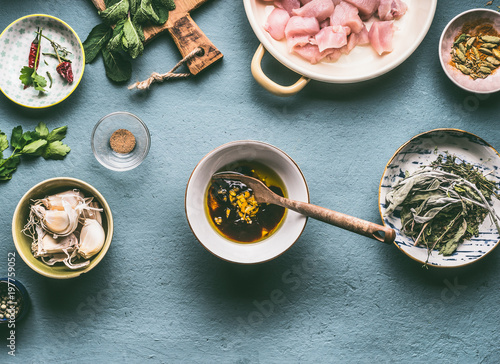 Chicken meal cooking concept. Chicken meat oil and soy sauce marinate in bowl on kitchen tables background with ingredients, top view
