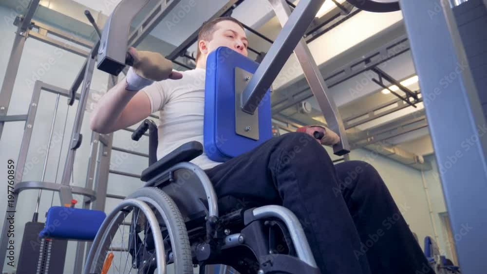 Bottom view of an lift-weighting exercising process of a disabled man Bottom view of an lift-weighting exercising process of a disabled man