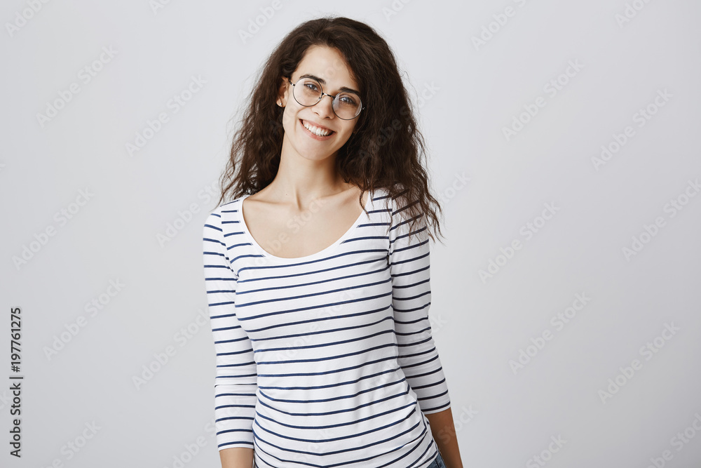 Happy to be in crowd of friends. Portrait of pleased charming curly-haired daughter in glasses smiling cheerfully, expressing friendly attitude while teaching children on part-time job Happy to be in crowd of friends. Portrait of pleased charming curly-haired daughter in glasses smiling cheerfully, expressing friendly attitude while teaching children on part-time job