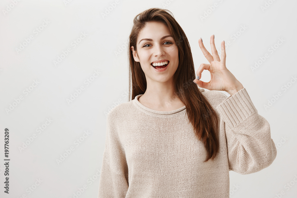 Woman will make sure everything will go fine. Portrait of friendly assured caucasian girl smiling positively raising hand near face, showing okay or great gesture, being confident in good result Woman will make sure everything will go fine. Portrait of friendly assured caucasian girl smiling positively raising hand near face, showing okay or great gesture, being confident in good result