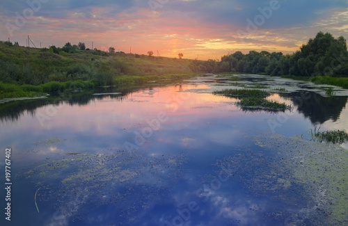 Fototapeta Naklejka Na Ścianę i Meble -  Beautiful summer landscape.Bright purple clouds over the surface of river.Summer sunrise.River Upa in Tula region,Russia. 