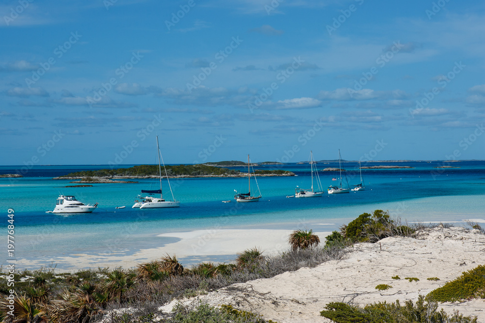 A string of boats at the isolated anchorage of Warderick Wells in the Bahamas.