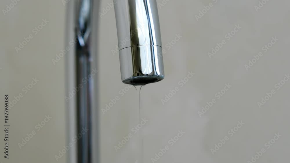 Close-up abstract a droplets of water drip from the tap in the kitchen at home. Close-up abstract a droplets of water drip from the tap in the kitchen at home.