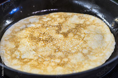 Pancakes for carnival are baked in a frying pan, on a plate