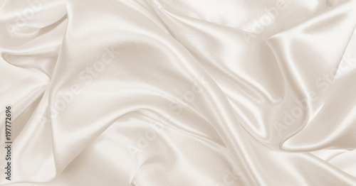 Smooth elegant golden silk or satin luxury cloth texture as wedding background. Luxurious Christmas background or New Year background design. In Sepia toned. Retro style