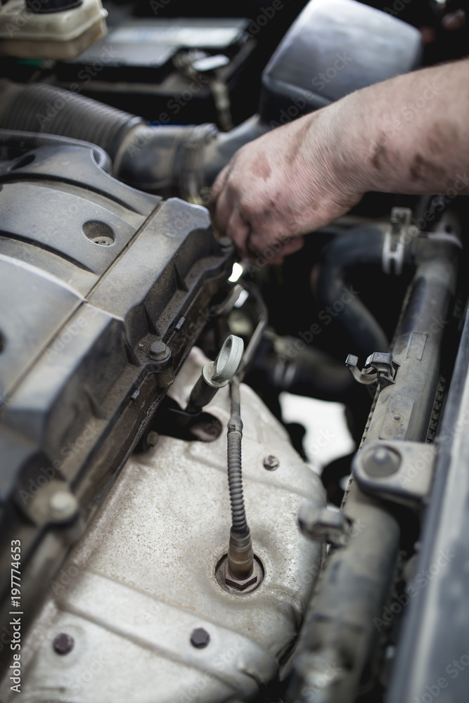 Close up shot of worker hands repairing car engine Close up shot of worker hands repairing car engine