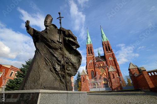 Statue of John Paul II against the background of the cathedral (Rybnik, Poland)