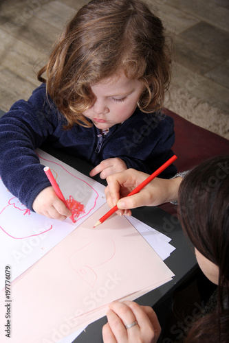 mother and daughter drawing together at home.