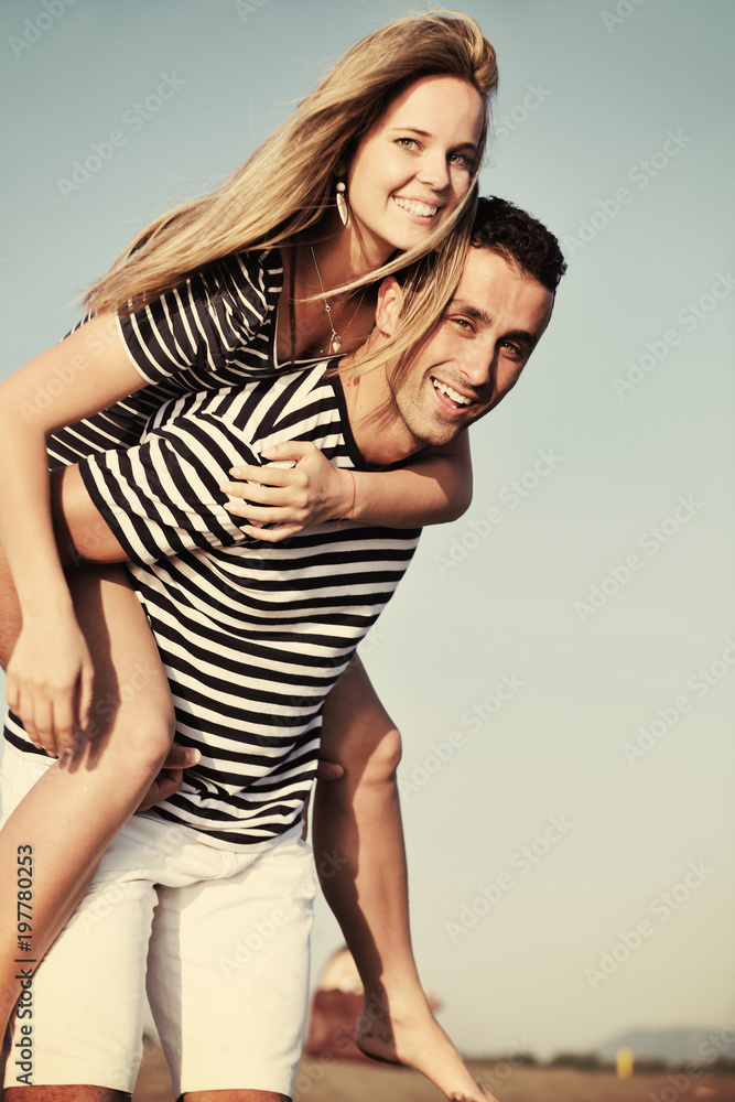 happy young couple have romantic time on beach happy young couple have romantic time on beach