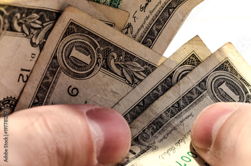 dollars, dollars, dollars! close up of human hand counting dollars. photo