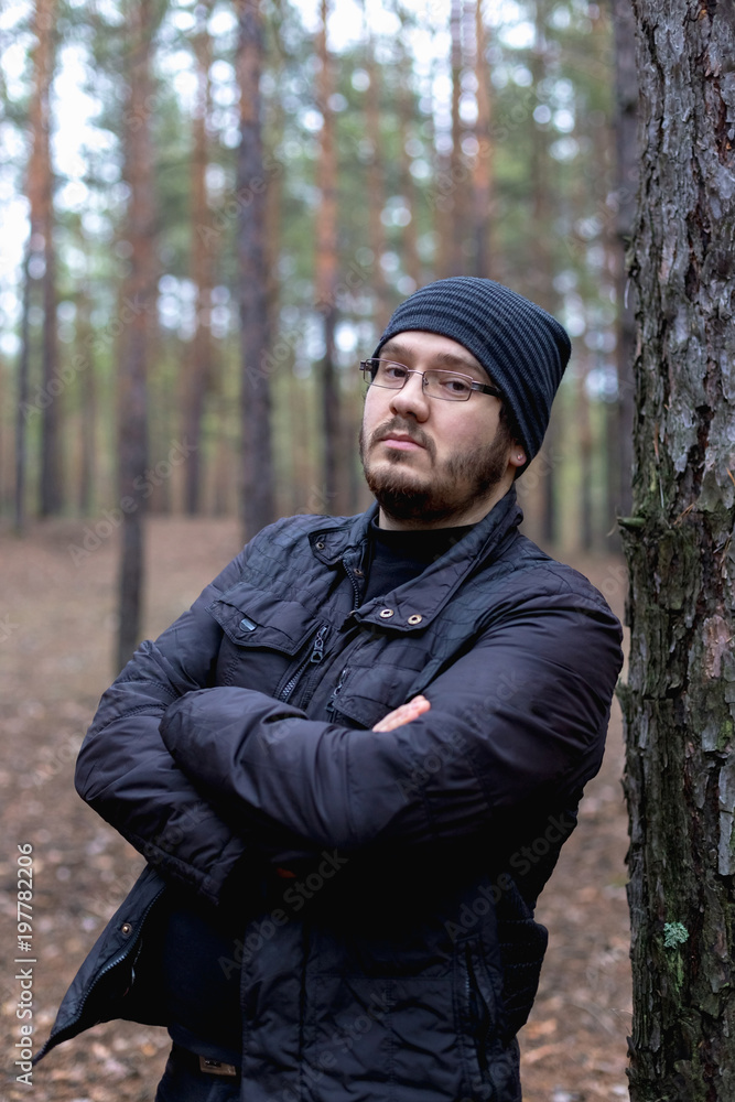 Portrait of a fat young man in a pine forest Portrait of a fat young man in a pine forest