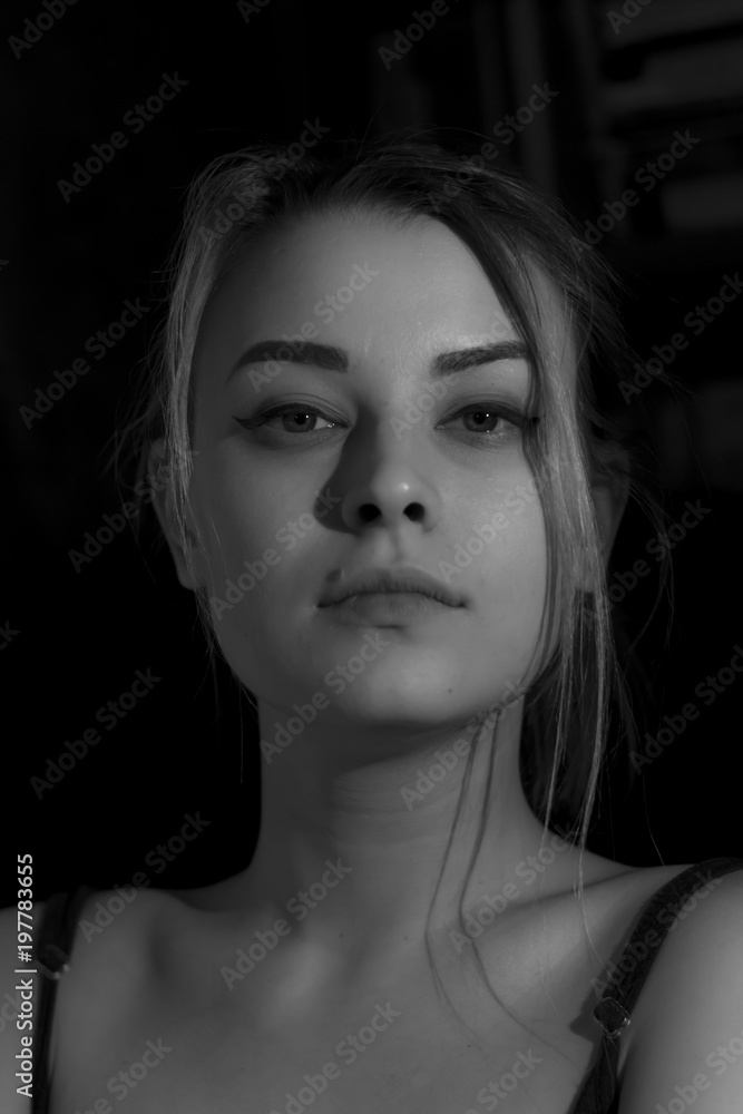 Beautiful sensual blonde girl. Close-up of an attractive girl of European appearance on dark background. Beautiful sensual blonde girl. Close-up of an attractive girl of European appearance on dark background.