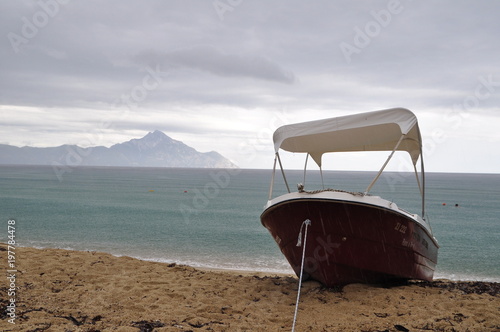 Small boat on the beach, Sithonia, Greece. In the background you can see Mount Áthos.