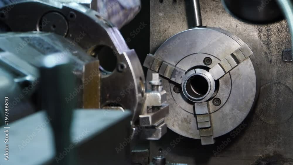 Close up hand heavy industrial worker is working on metal work factory process by performing mechanical turning operation at machine for steel structure industry Close up hand heavy industrial worker is working on metal work factory process by performing mechanical turning operation at machine for steel structure industry