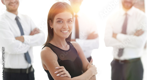 young employee of the company, standing in front of their collea photo