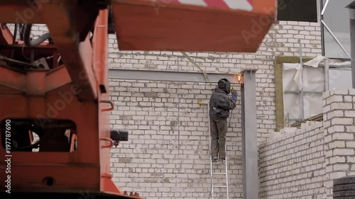 Wallpaper Mural Professional works with a welding machine on a construction site. Torontodigital.ca