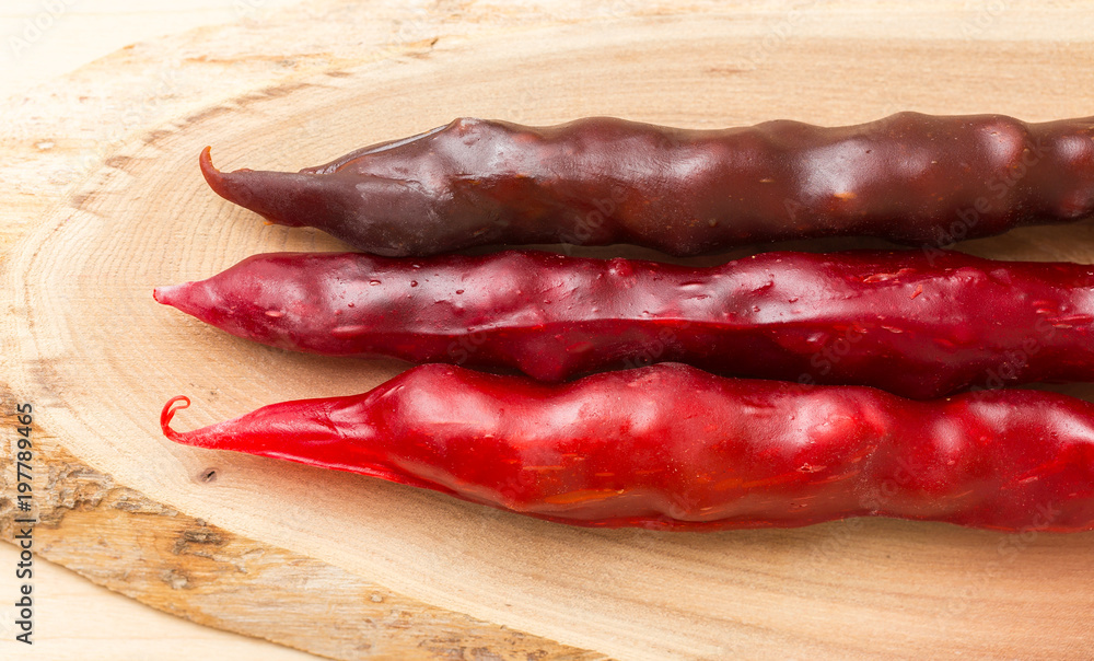 Colorful fruit leather rolls on mats of crushed fruit ( tklapi ). Fruit candy - pastille.Top view.