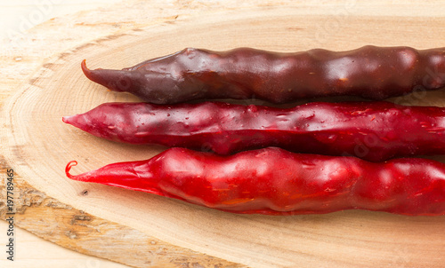 Colorful fruit leather rolls on mats of crushed fruit ( tklapi ). Fruit candy - pastille.Top view. photo