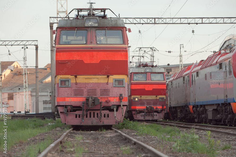 View on the railway track with old locomotives and operational locomotive depot. Transportation concept View on the railway track with old locomotives and operational locomotive depot. Transportation concept