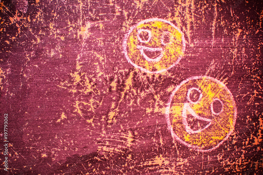 smiley drawn chalk on an old school board