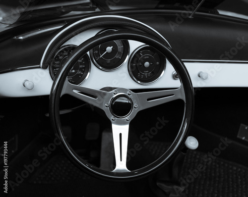 Wooden steering wheel and leather dashboard of a vintage car