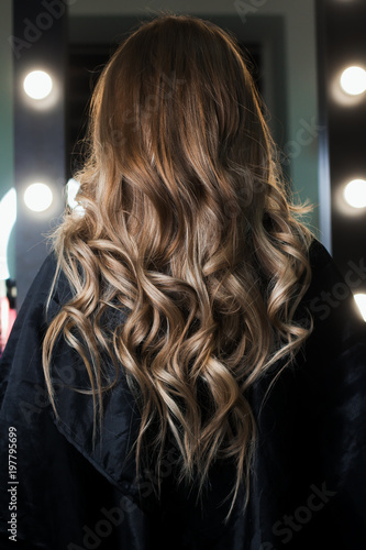 Elegant hair styling. Hair shines and beautifully curled in curls. The final result after the work of the hairdresser. I photographed in the beauty salon