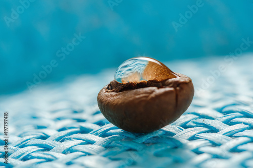 roasted, fragrant coffee grains macro on blue background photo