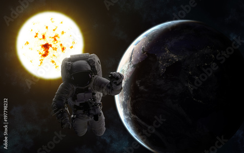 Fototapeta Naklejka Na Ścianę i Meble -  Astronaut. Sun and Earth. Image in 5K resolution for desktop wallpaper. Elements of the image are furnished by NASA