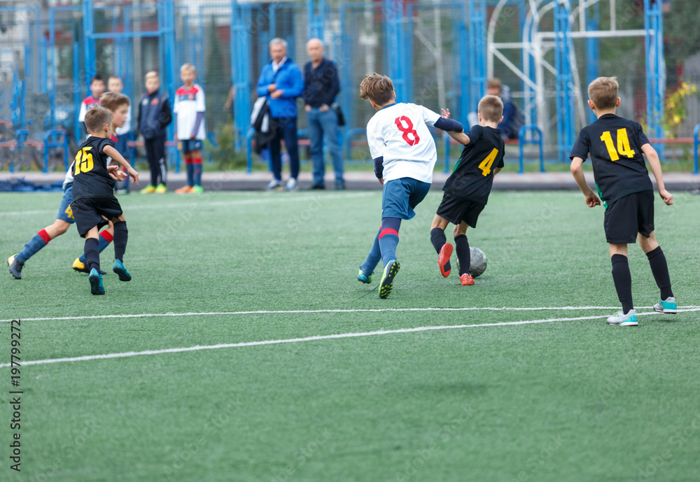 young boys play football, show dribbling, make passes to win on the summer spring field young boys play football, show dribbling, make passes to win on the summer spring field